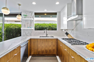 2649 Kings Road West Palm Springs, CA 92264 - Photo 26 of 50 a kitchen with kitchen island granite countertop a sink and a stove