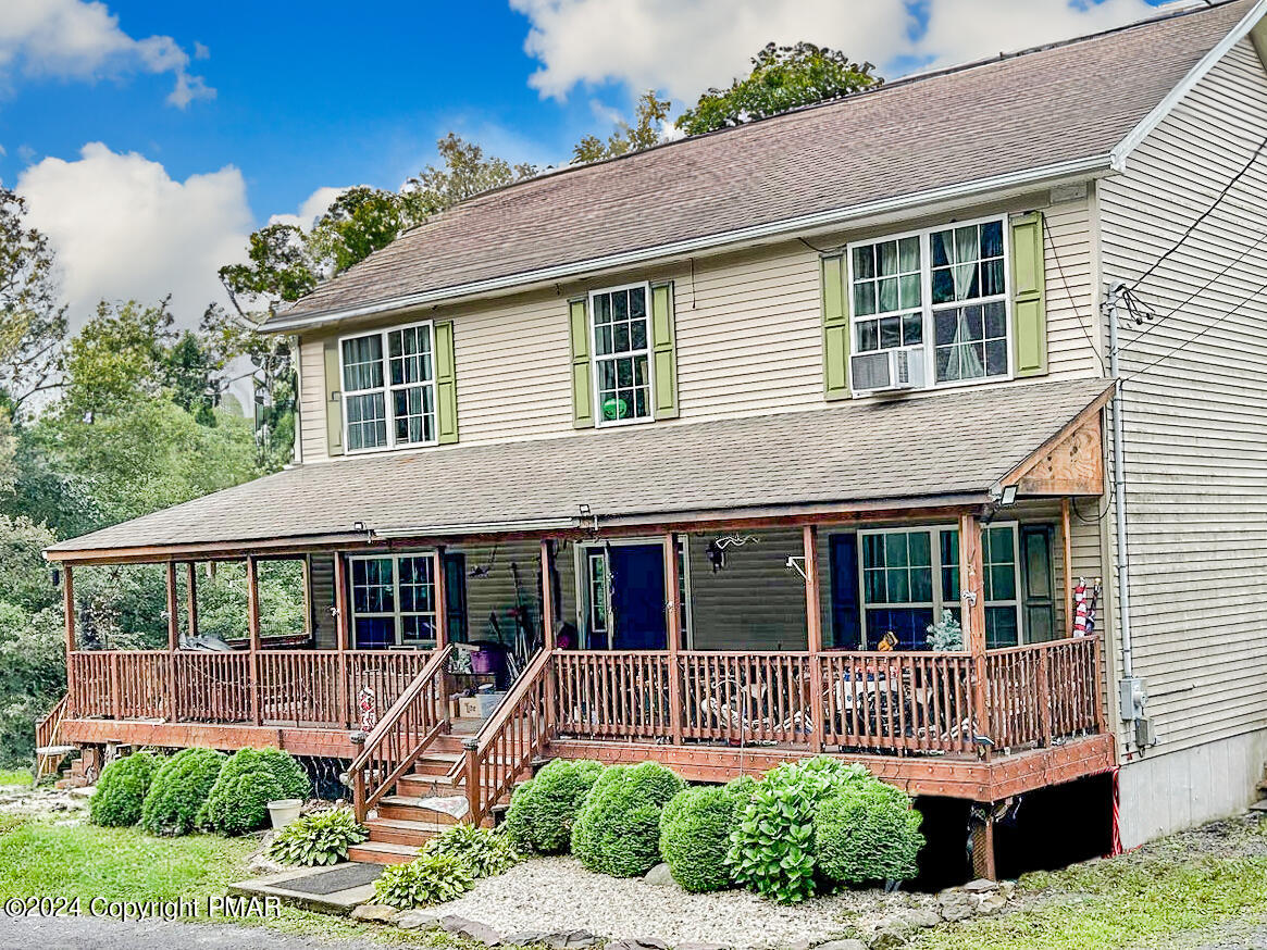 234 Shiffer Road Stroudsburg, PA 18360 - Photo 1 of 14 a front view of a house with a yard table and chairs