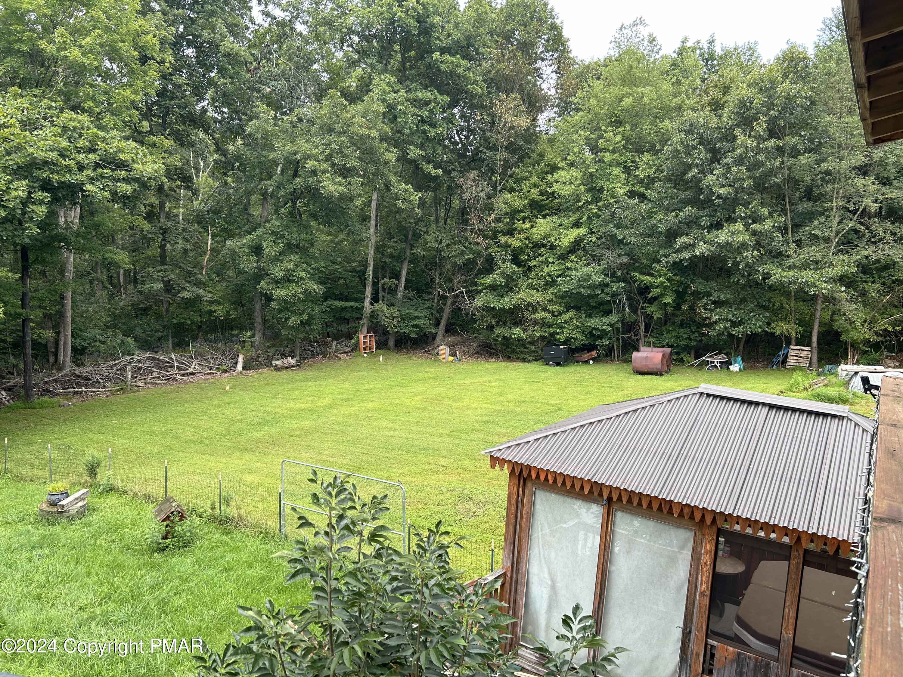 234 Shiffer Road Stroudsburg, PA 18360 - Photo 13 of 14 a view of swimming pool with a garden and trees