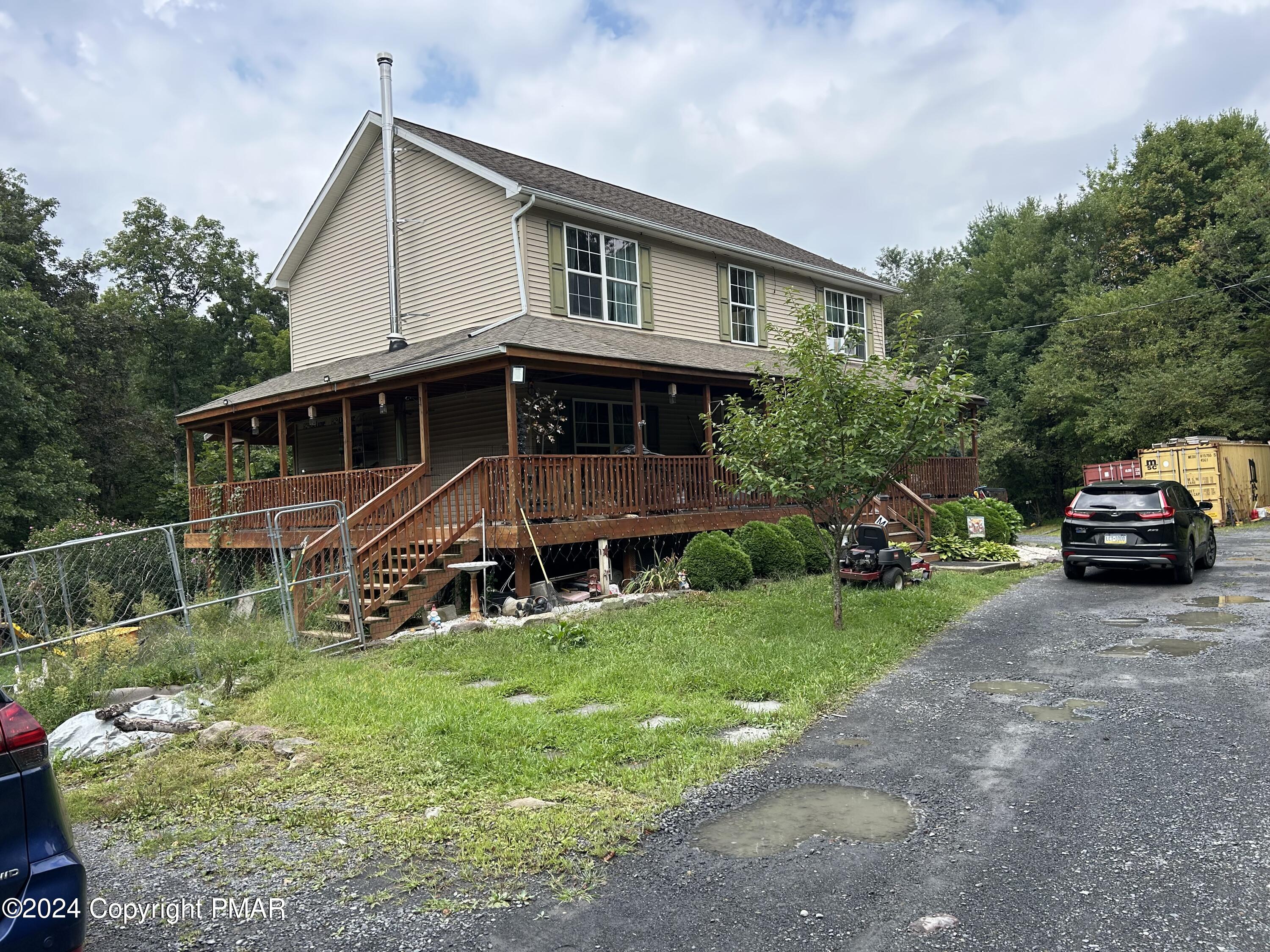234 Shiffer Road Stroudsburg, PA 18360 - Photo 2 of 14 a front view of a house with a garden and trees