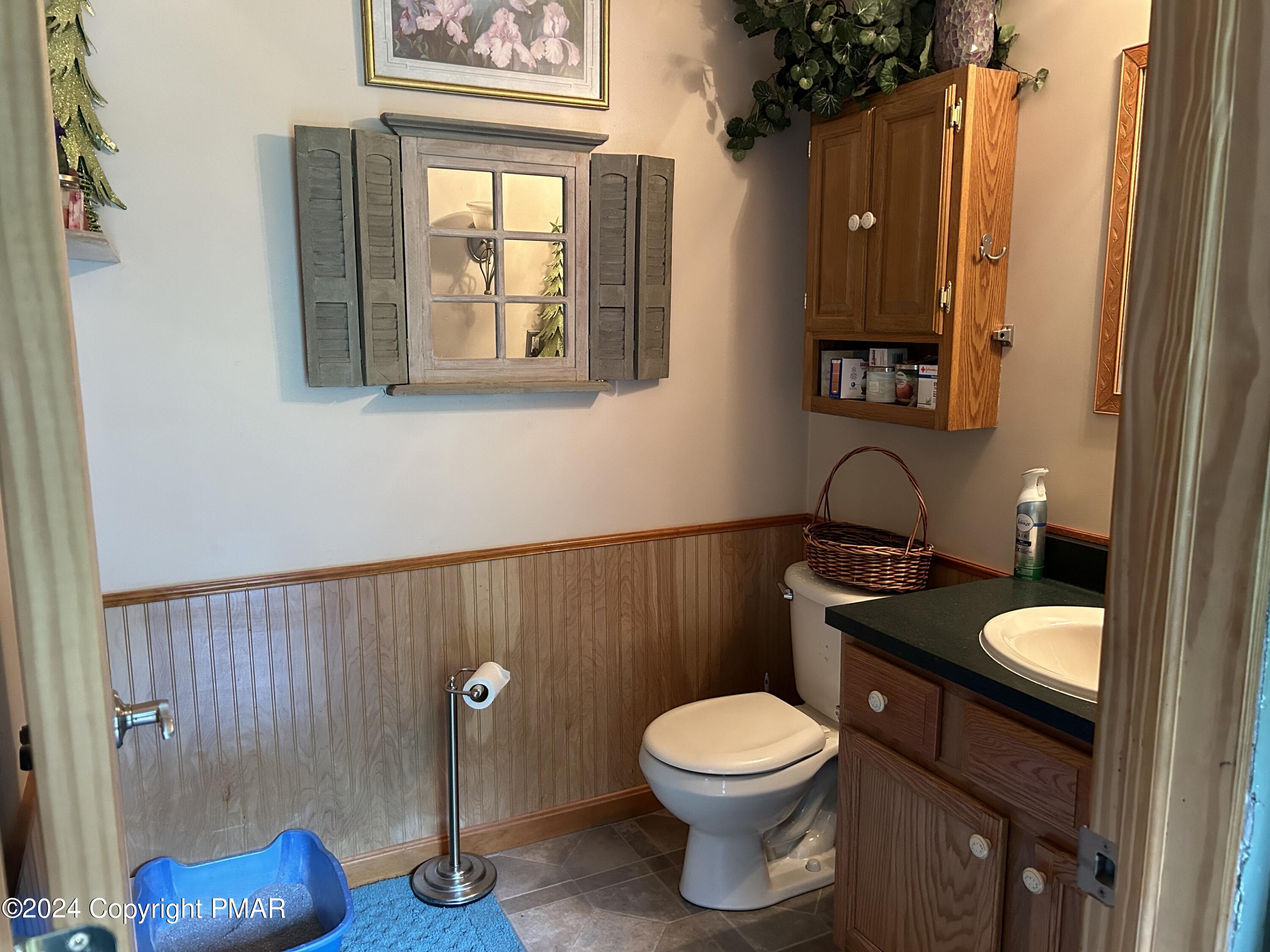 234 Shiffer Road Stroudsburg, PA 18360 - Photo 8 of 14 a bathroom with a toilet a sink and mirror