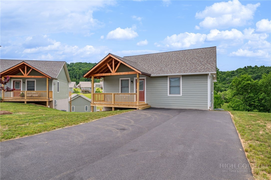 233 Ava Way, Unit 109 Boone, NC 28607 - Photo 3 of 27 a view of a house with a yard and large tree