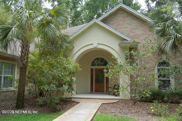 12819 Mandarin Road Jacksonville, FL 32223 - Photo 1 of 18 a front view of a house with garden