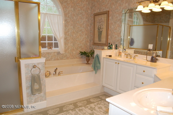 12819 Mandarin Road Jacksonville, FL 32223 - Photo 11 of 18 a bathroom with a tub sink and mirror