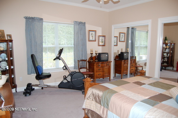 12819 Mandarin Road Jacksonville, FL 32223 - Photo 12 of 18 a bedroom with bed tv and window