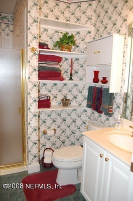12819 Mandarin Road Jacksonville, FL 32223 - Photo 14 of 18 a bathroom with a toilet and a sink