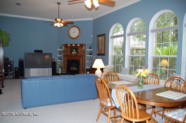 12819 Mandarin Road Jacksonville, FL 32223 - Photo 3 of 18 a view of a dining room with furniture a chandelier and a large window