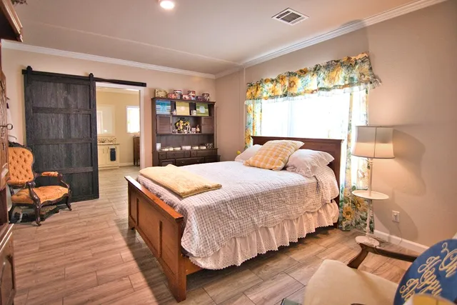 a bedroom with a bed and wooden floor