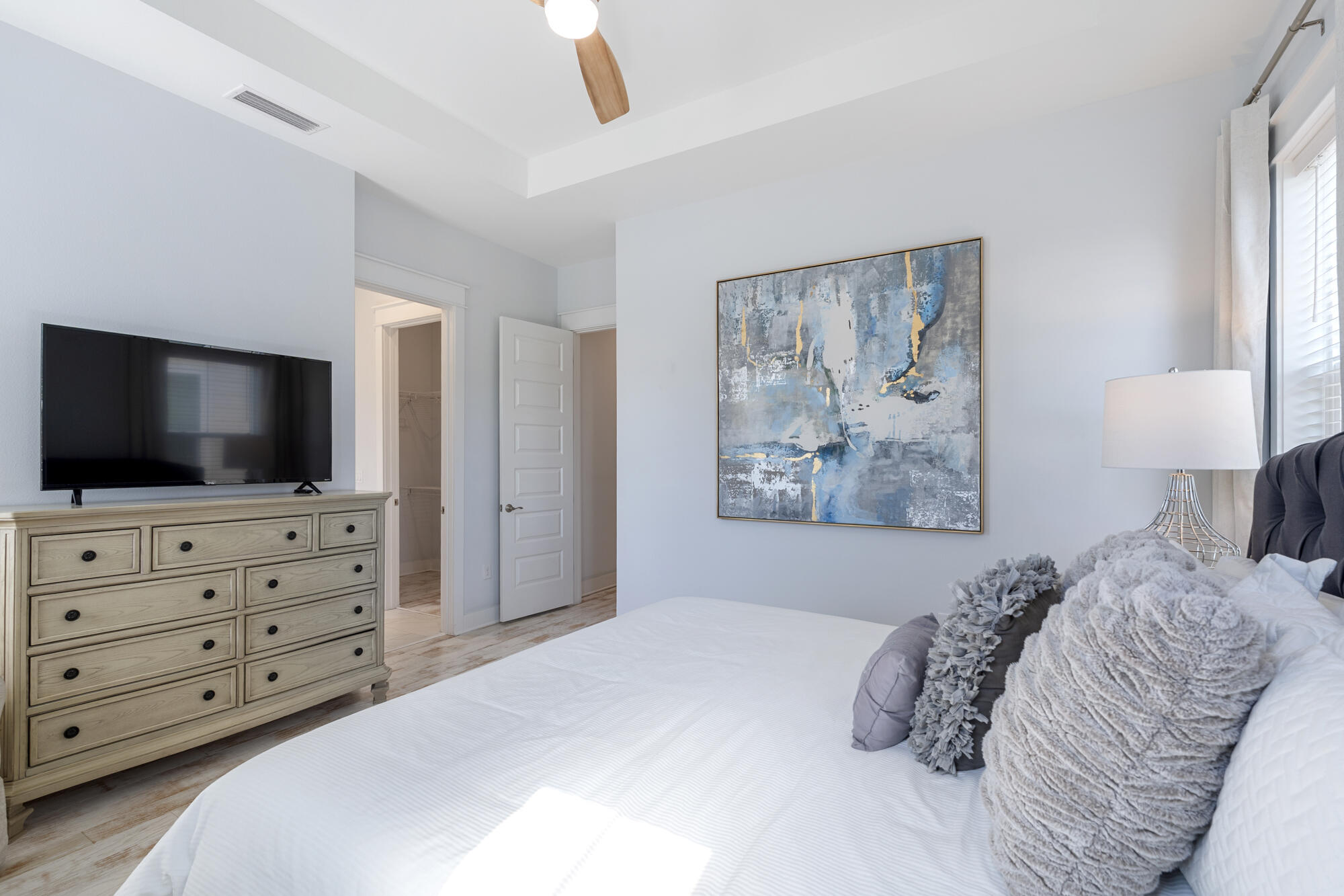 296 Milestone Dr Inlet Beach, Unit A Inlet Beach, FL 32461 - Photo 17 of 41 a bedroom with a large bed and a flat screen tv