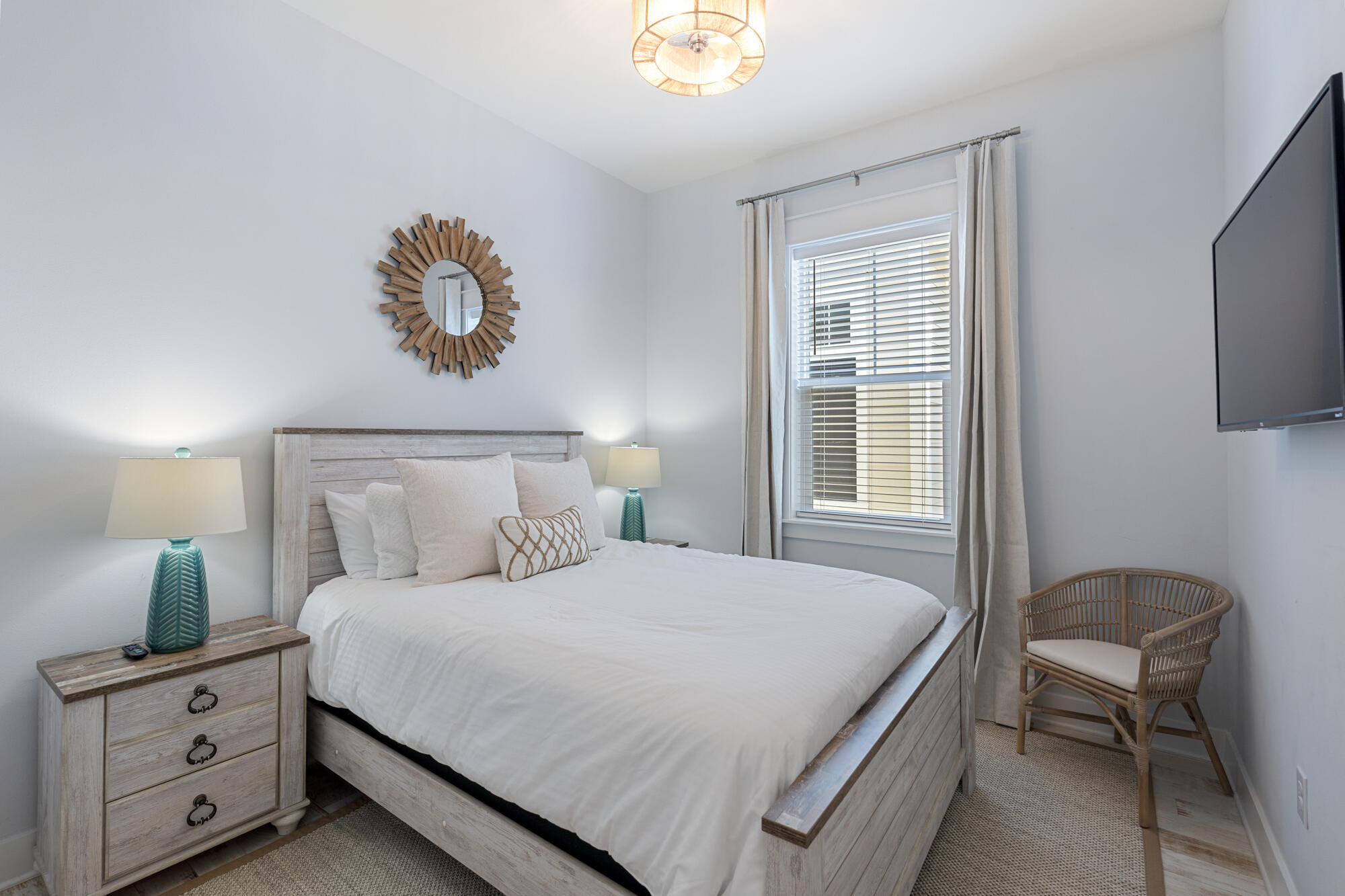 296 Milestone Dr Inlet Beach, Unit A Inlet Beach, FL 32461 - Photo 20 of 41 a bedroom with a bed and a chandelier