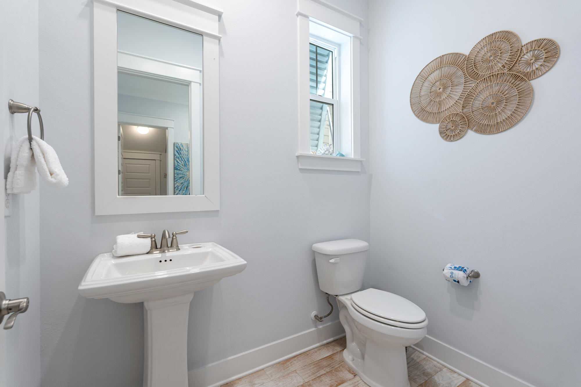 296 Milestone Dr Inlet Beach, Unit A Inlet Beach, FL 32461 - Photo 24 of 41 a bathroom with a toilet sink and mirror