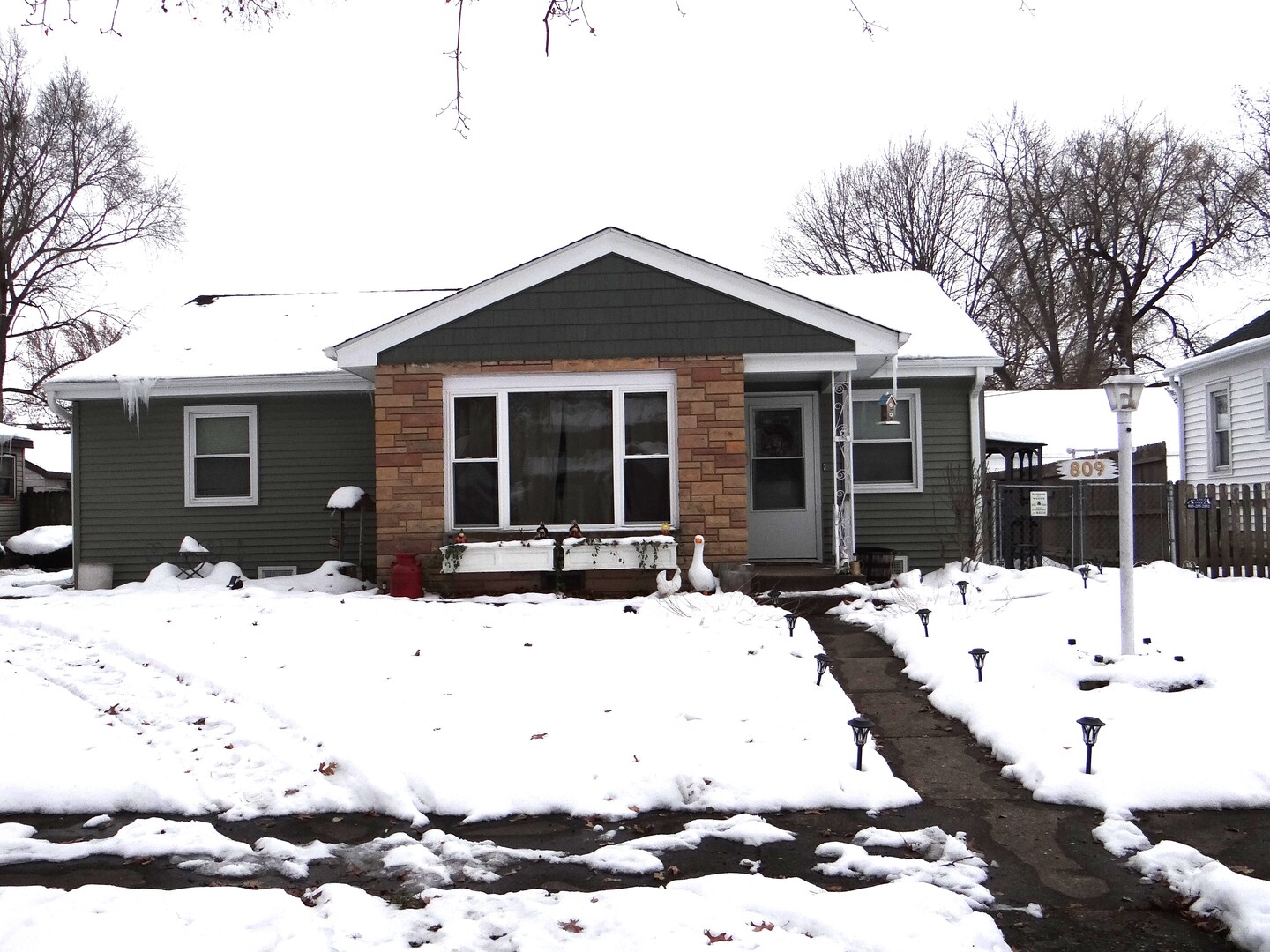 809 Douglas Street Morris, IL 60450 - Photo 1 of 22 a view of a house with a yard covered in snow