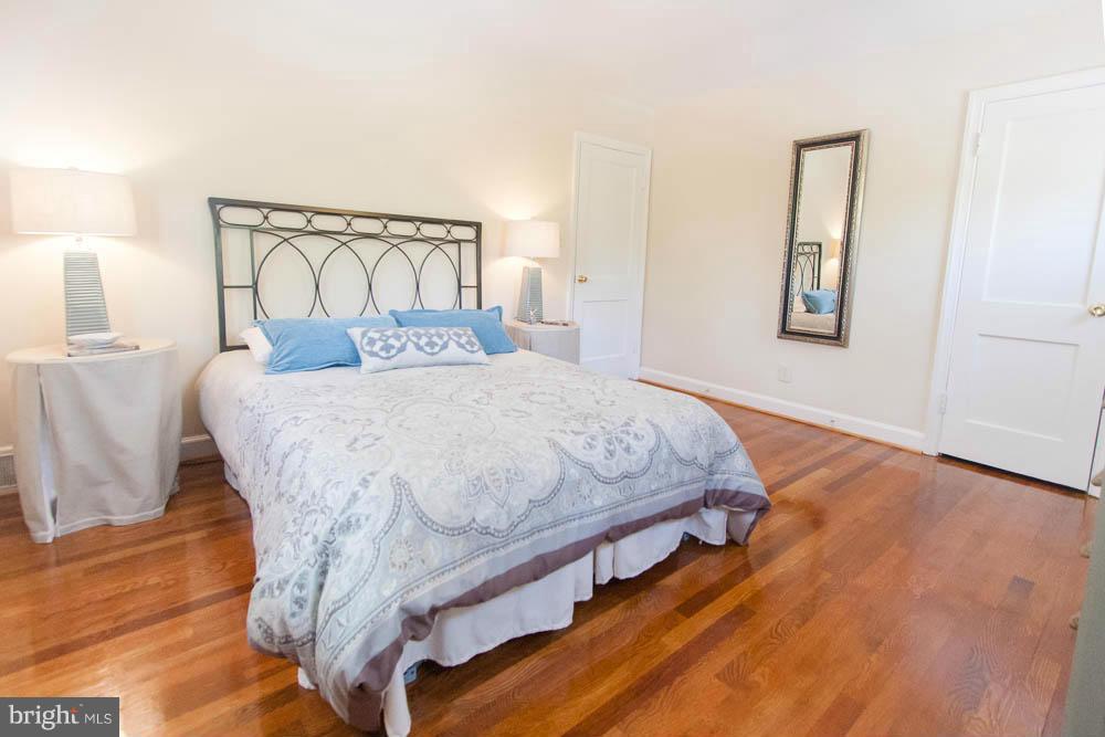 106 South Glebe Road Arlington, VA 22204 - Photo 17 of 28 a bedroom with a bed and wooden floor