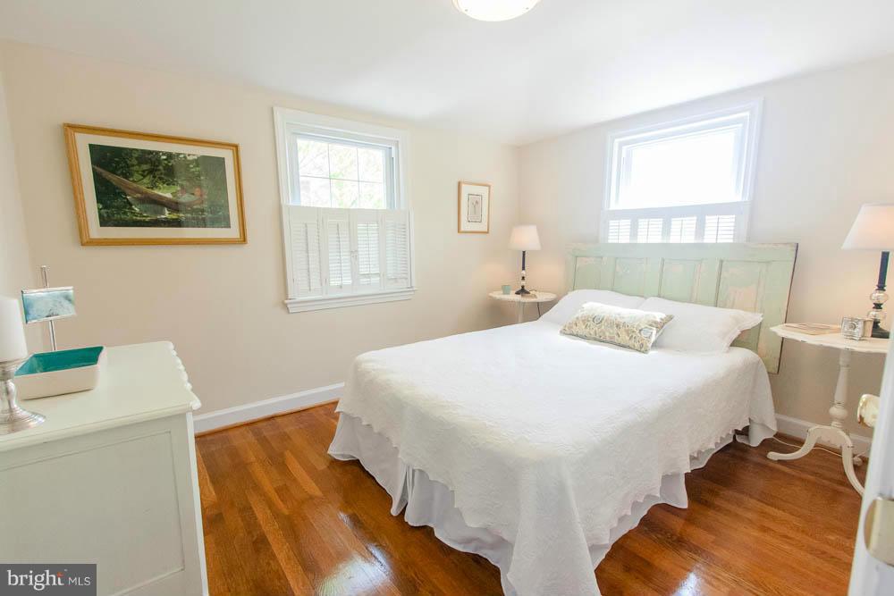 106 South Glebe Road Arlington, VA 22204 - Photo 22 of 28 a bedroom with a bed and wooden floor