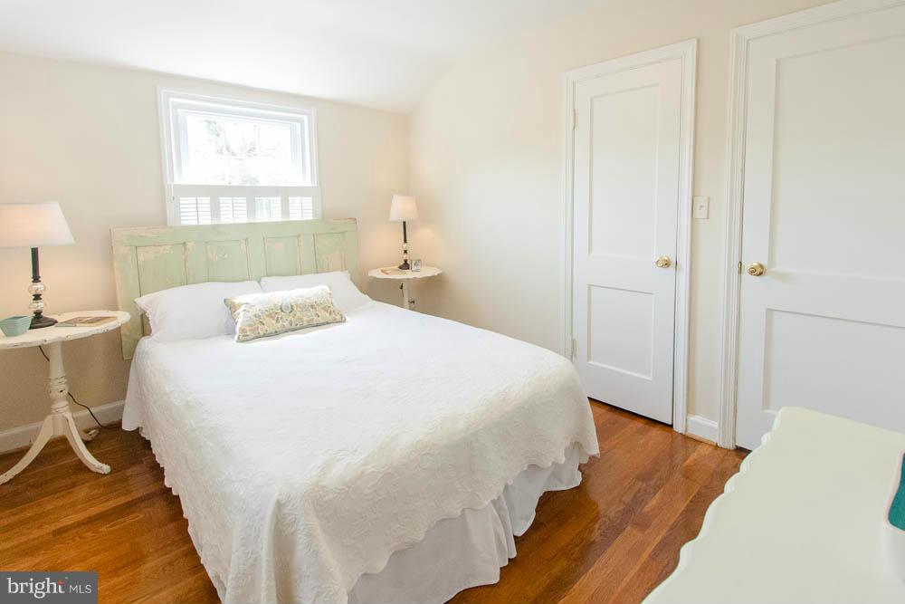 106 South Glebe Road Arlington, VA 22204 - Photo 23 of 28 a bedroom with a bed and wooden floor