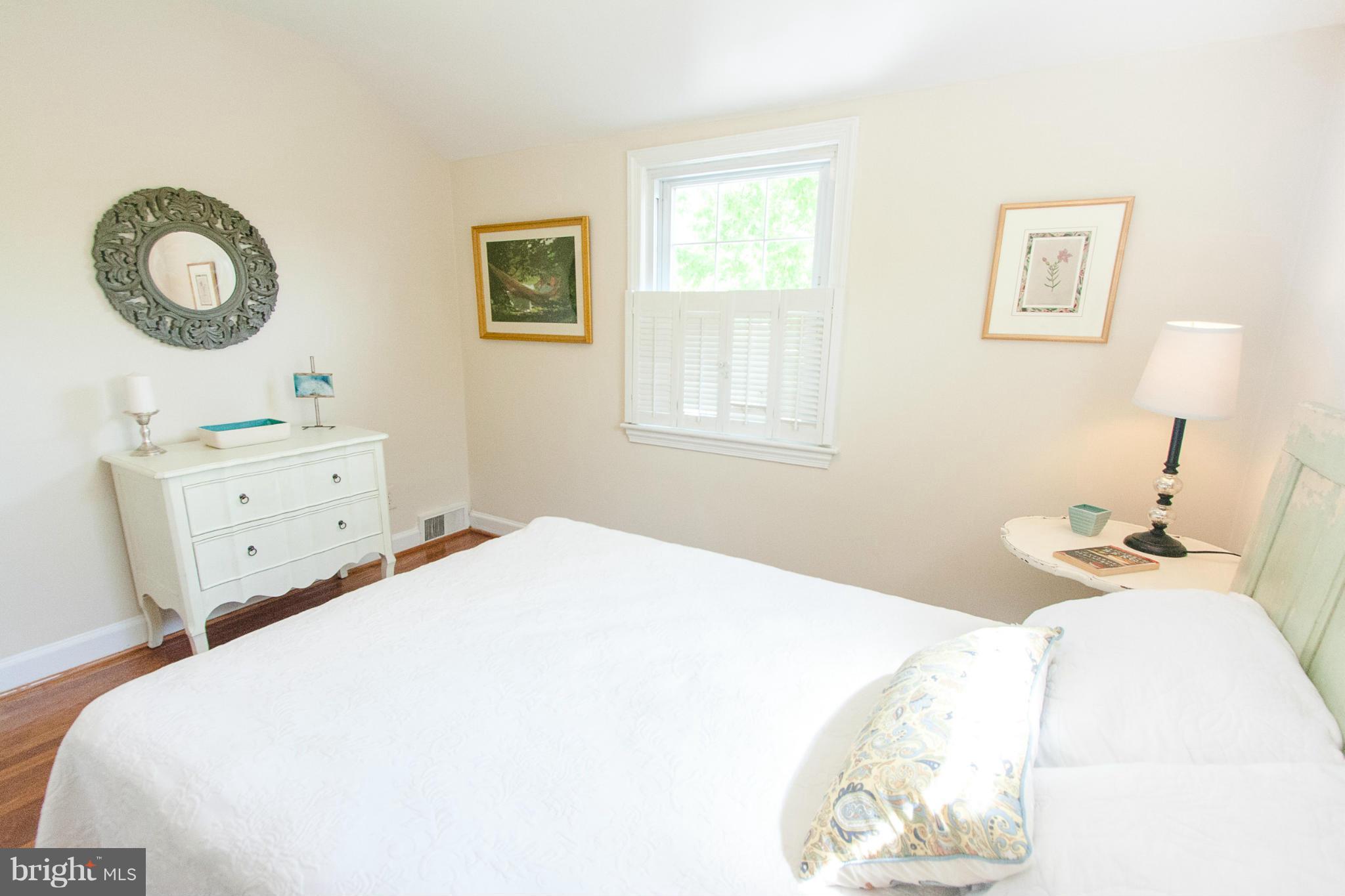106 South Glebe Road Arlington, VA 22204 - Photo 24 of 28 a bedroom with a bed and a lamp on dresser