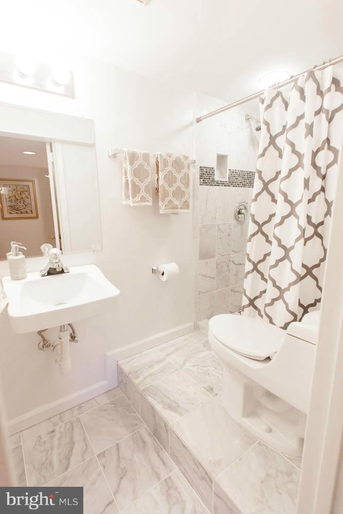 106 South Glebe Road Arlington, VA 22204 - Photo 27 of 28 a bathroom with a sink a toilet and shower