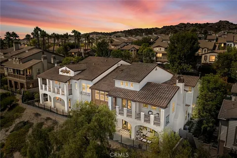 a aerial view of a house with a mountain in the background