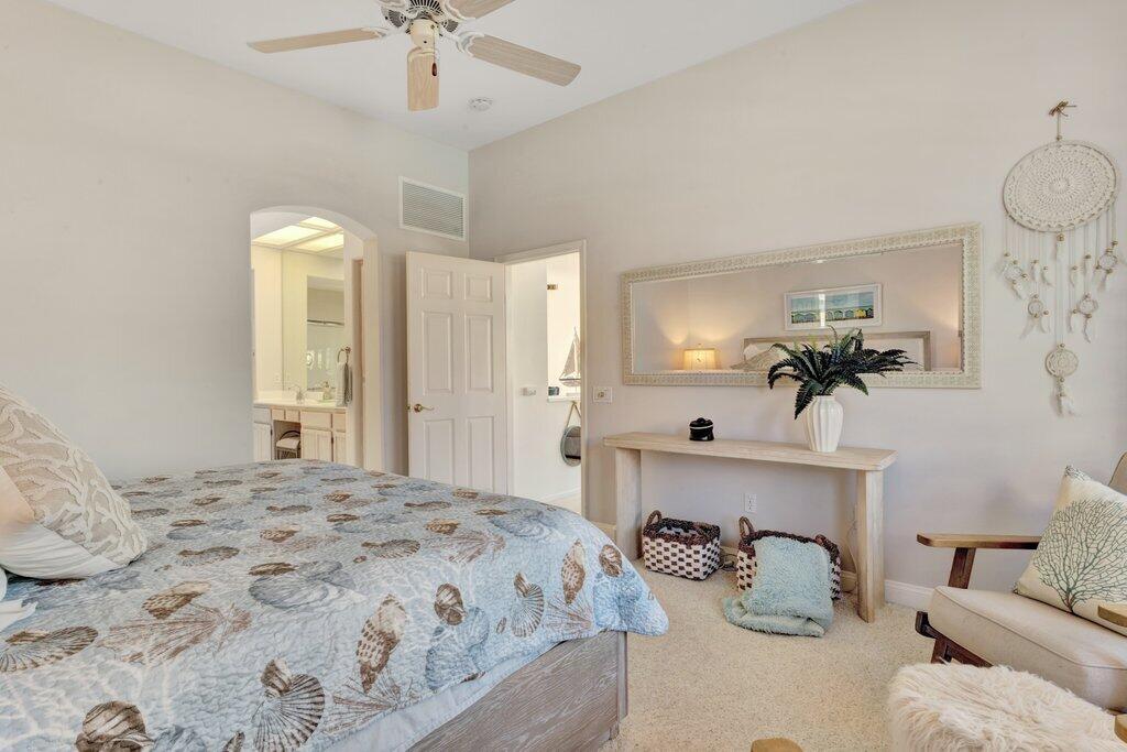 38635 Orangecrest Road Palm Desert, CA 92211 - Photo 14 of 34 a bedroom with bed and a chandelier