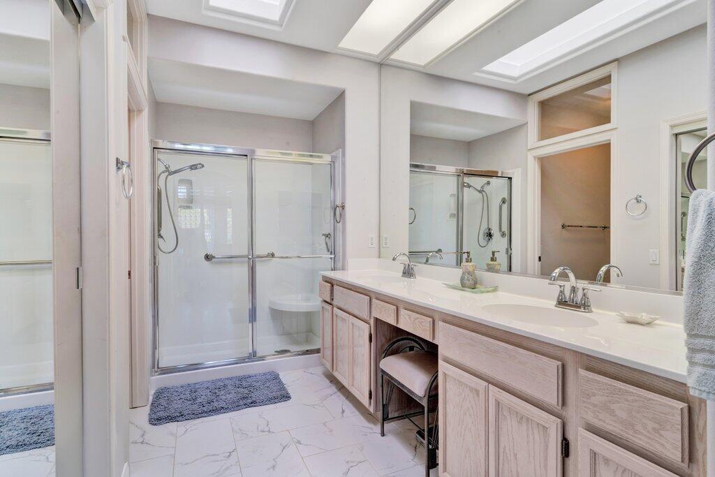 38635 Orangecrest Road Palm Desert, CA 92211 - Photo 16 of 34 a spacious bathroom with a shower sink and mirror