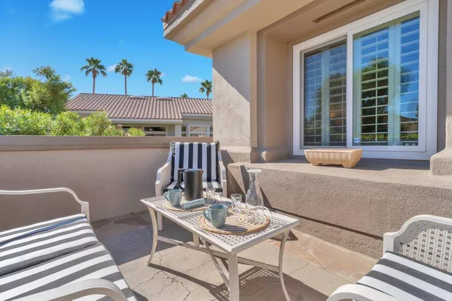 a view of a patio with table and chairs