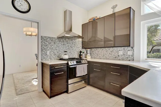 a kitchen with stainless steel appliances granite countertop a stove and a sink