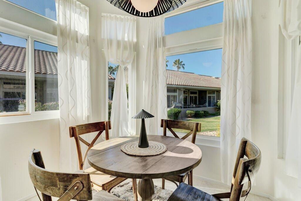 38635 Orangecrest Road Palm Desert, CA 92211 - Photo 9 of 34 a view of a dining room with furniture and wooden floor