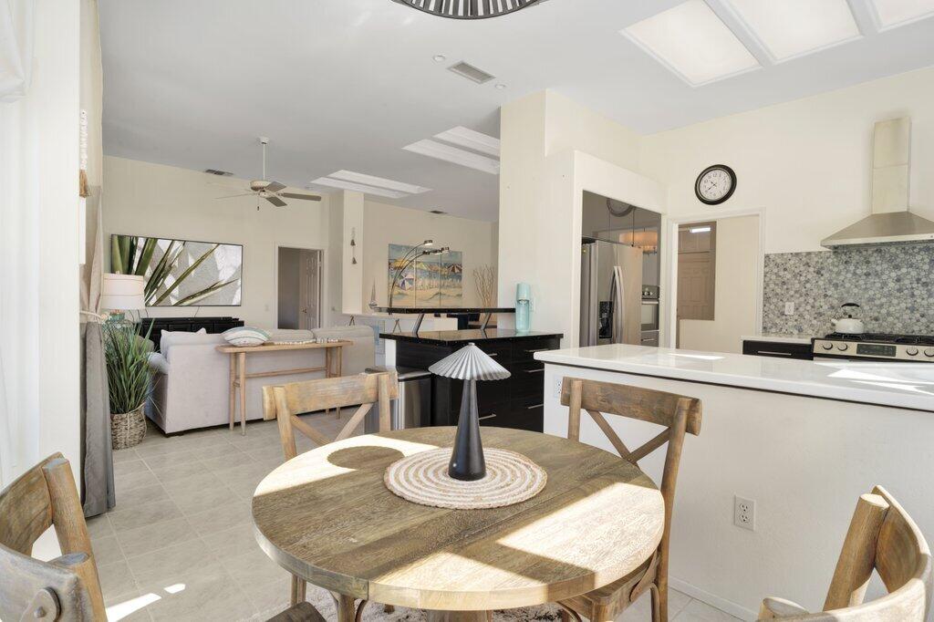 38635 Orangecrest Road Palm Desert, CA 92211 - Photo 10 of 34 a dining room with furniture and wooden floor
