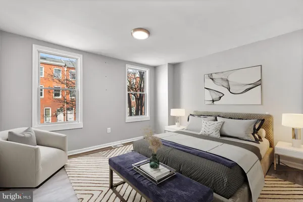 a bedroom with a bed couch and window