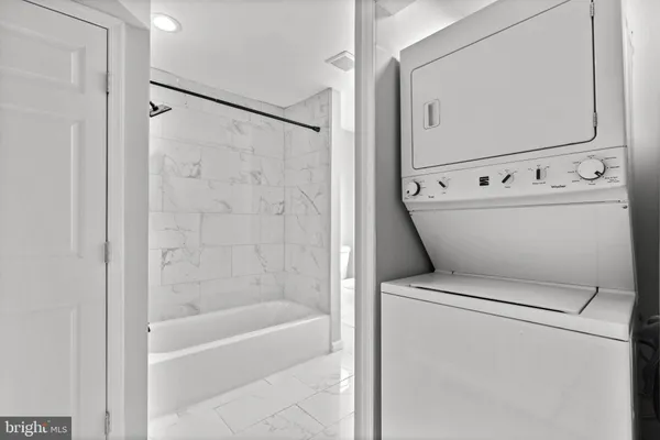 a white bath tub sitting next to a white sink