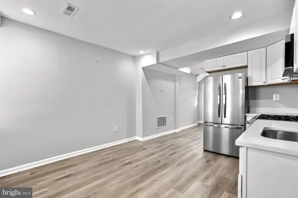 a kitchen with stainless steel appliances a refrigerator and a stove top oven