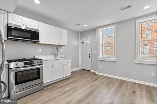a kitchen with a stove and a microwave