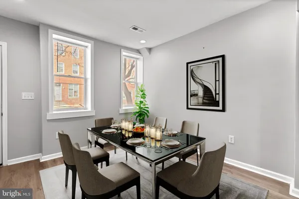 a dining room with furniture and window