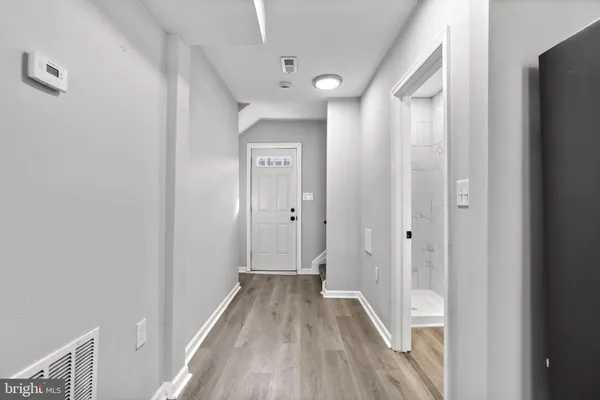 a view of a hallway with wooden floor