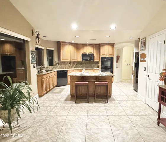 a living room with furniture a dining table and a potted plant
