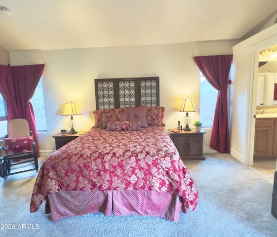 a bedroom with a bed and a potted plant