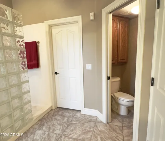 a bathroom with a toilet and a shower