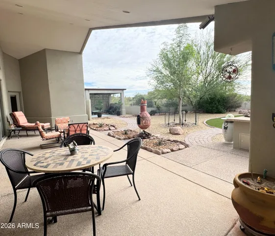 a dining room with furniture and a floor to ceiling window