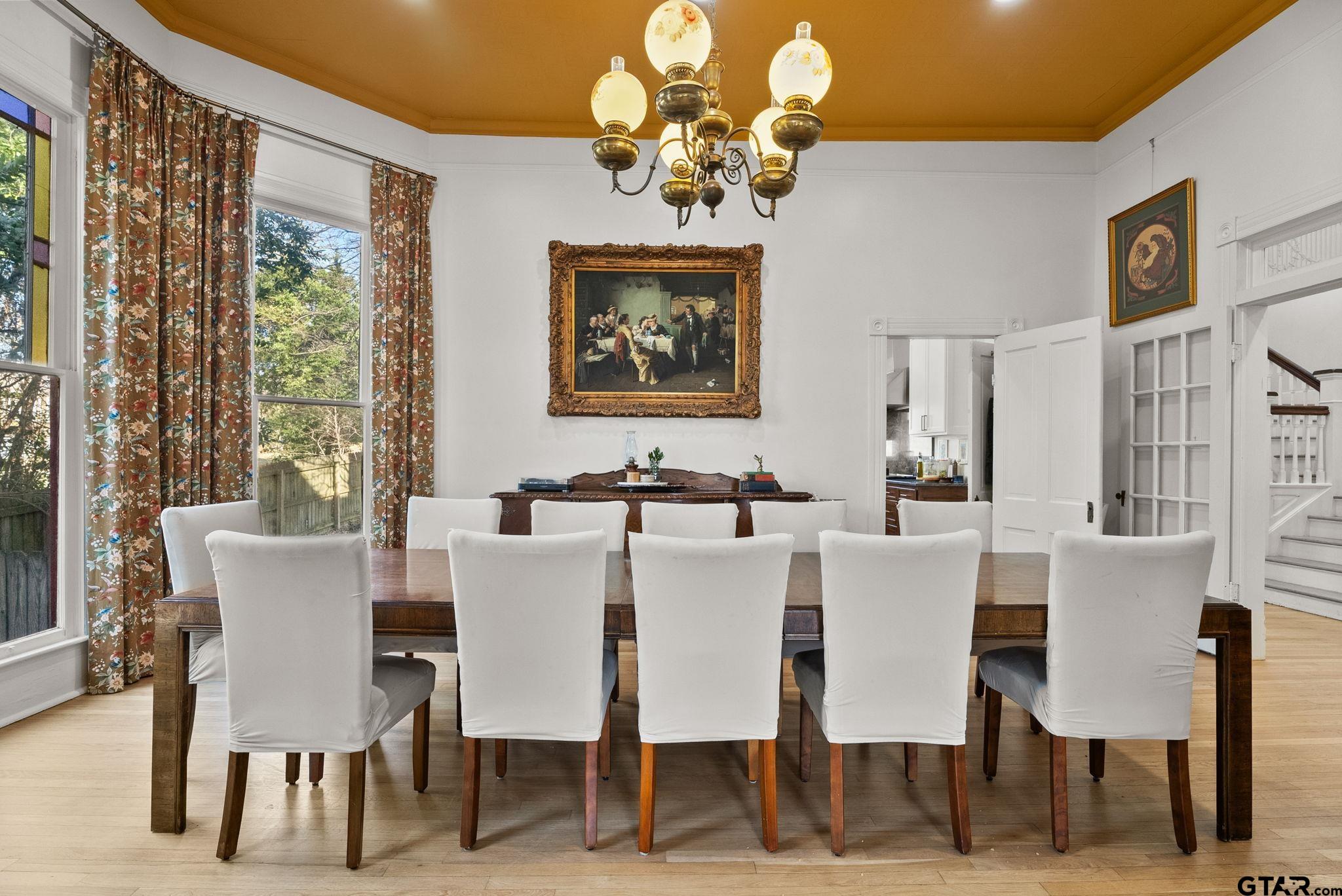 911 West Houston Street Tyler, TX 75702 - Photo 13 of 48 a view of a dining room with furniture a chandelier and large windows