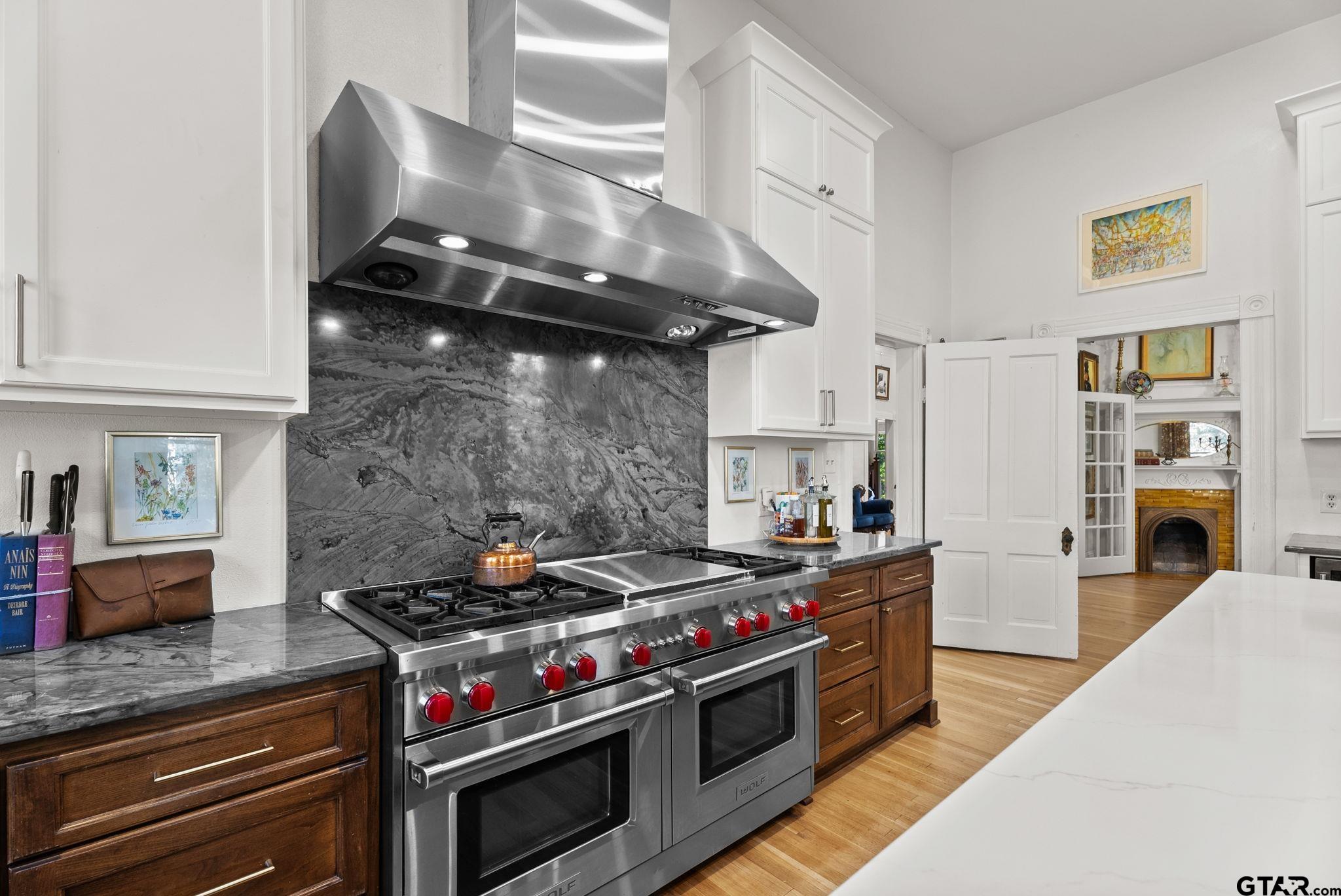 911 West Houston Street Tyler, TX 75702 - Photo 17 of 48 a kitchen with stainless steel appliances granite countertop a stove and a refrigerator