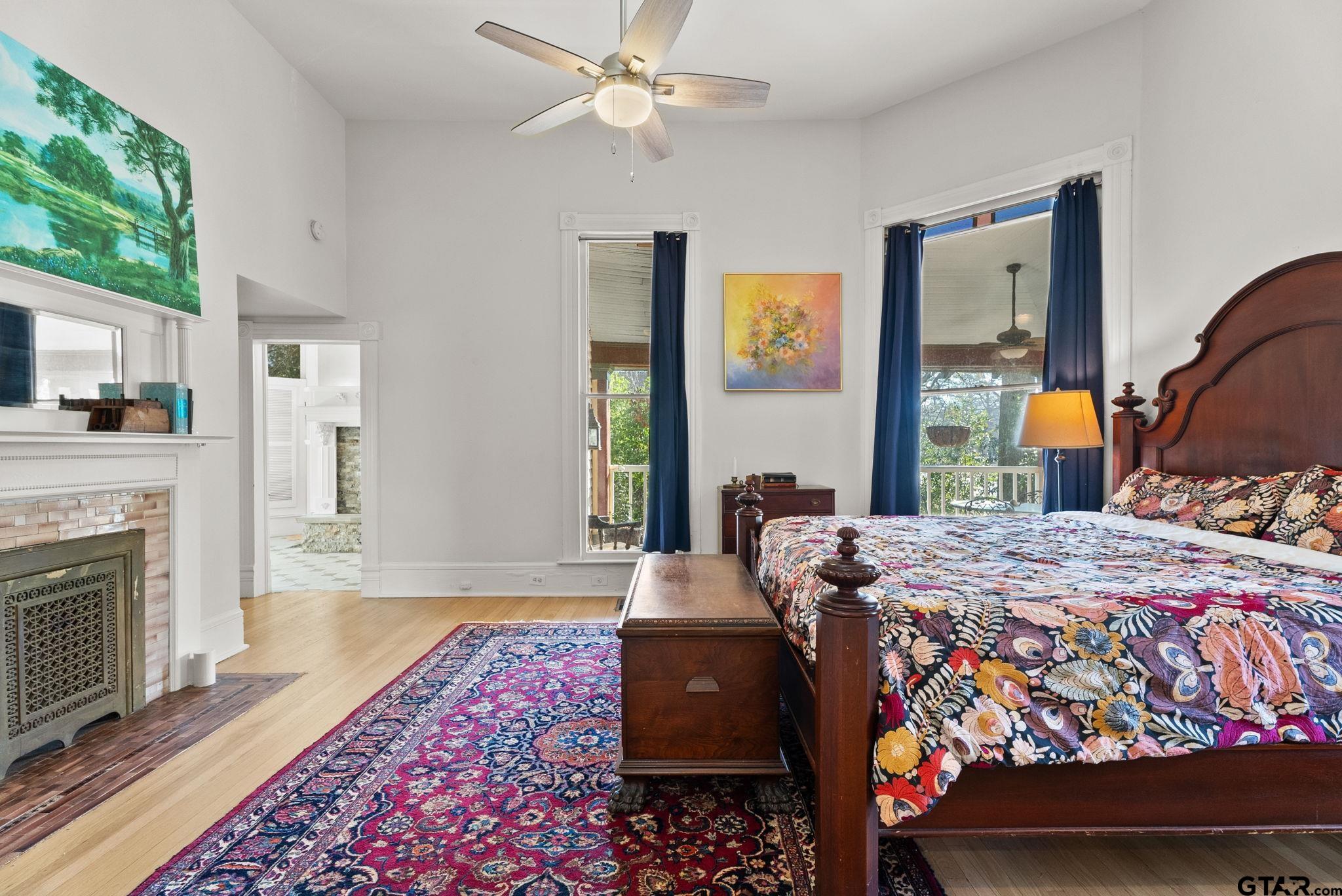 911 West Houston Street Tyler, TX 75702 - Photo 21 of 48 a bedroom with a bed and a fireplace