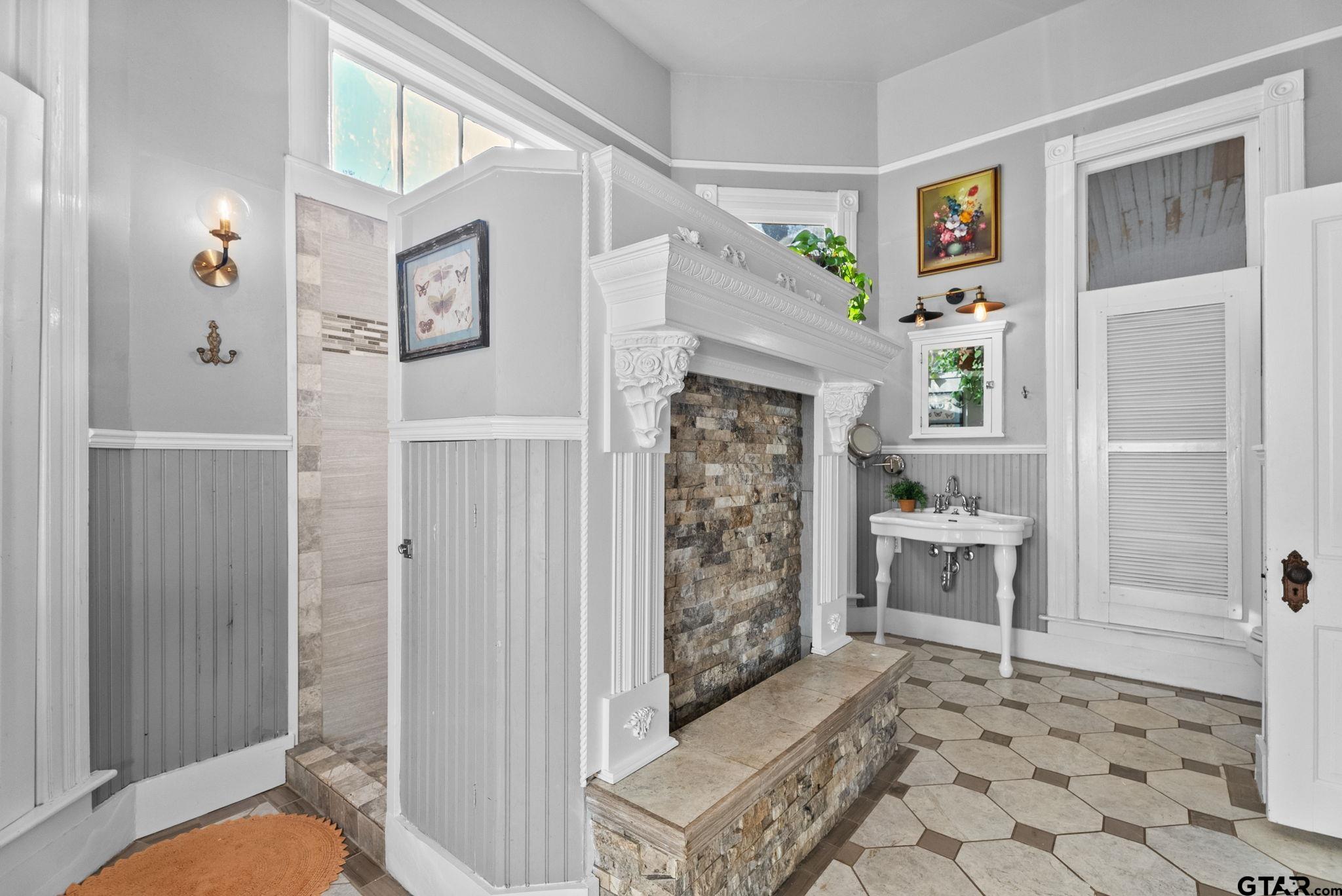 911 West Houston Street Tyler, TX 75702 - Photo 24 of 48 a bathroom with a granite countertop shower a toilet and a sink