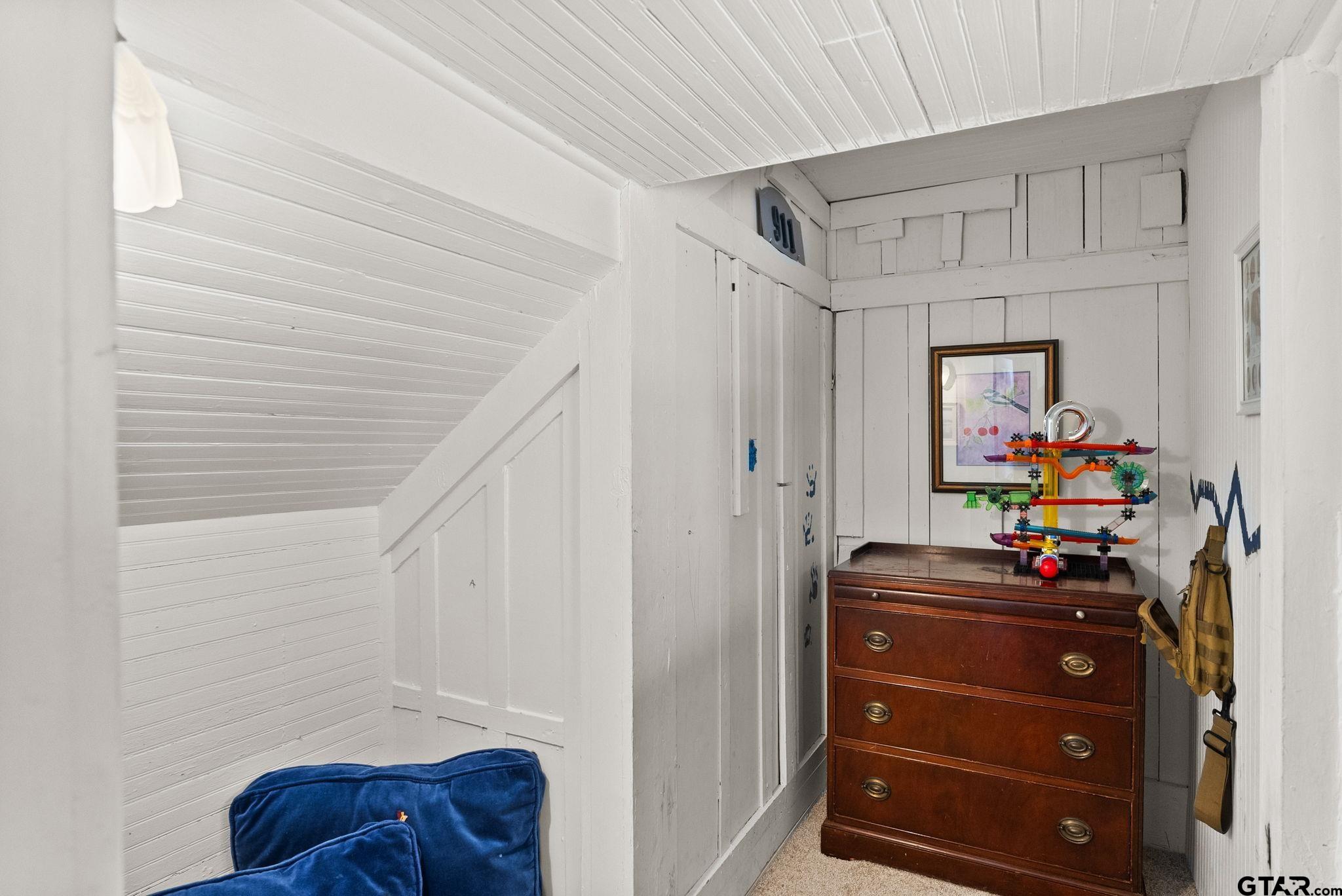 911 West Houston Street Tyler, TX 75702 - Photo 29 of 48 a room with a dresser and a potted plant