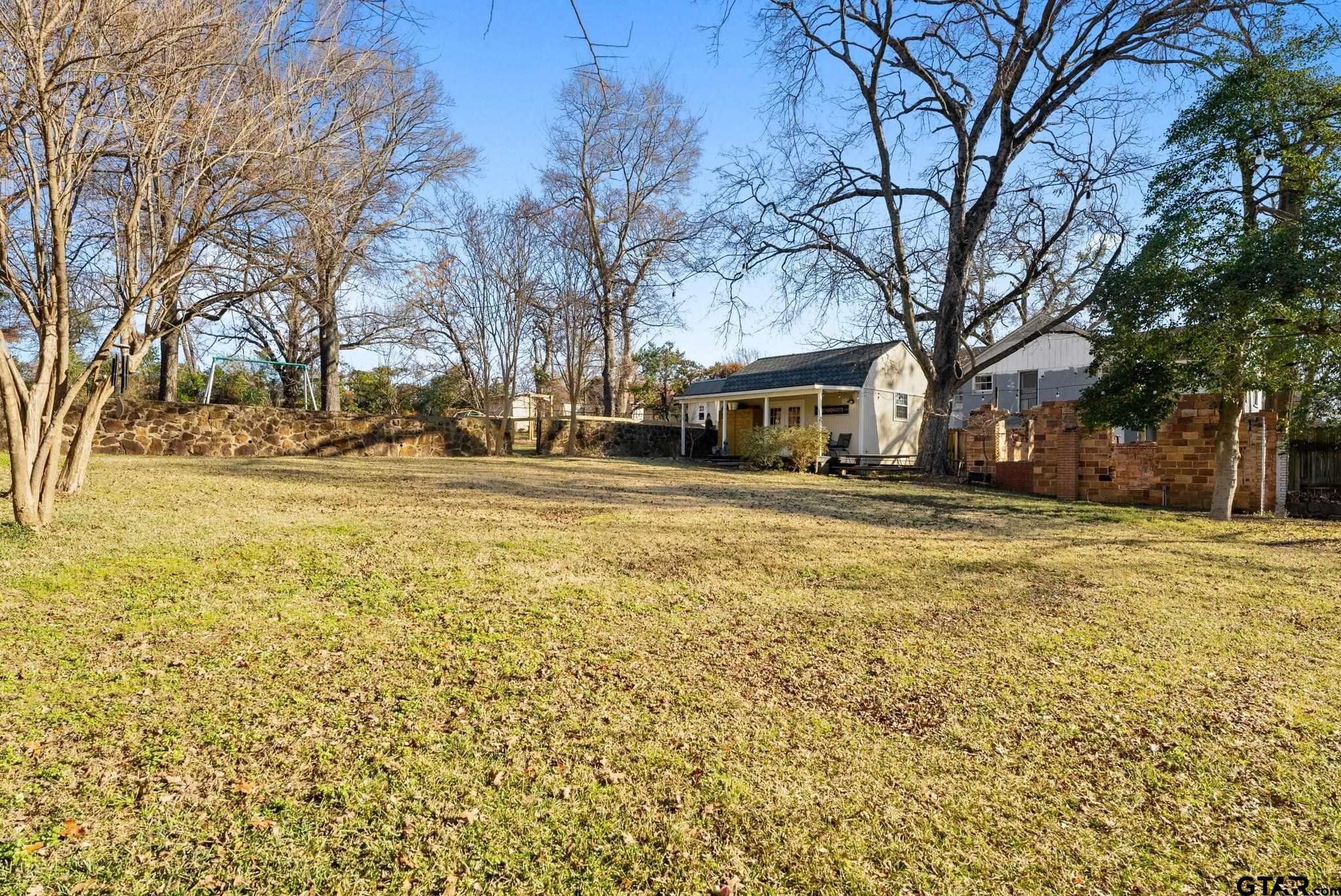 911 West Houston Street Tyler, TX 75702 - Photo 46 of 48 a view of yard with swimming pool and trees
