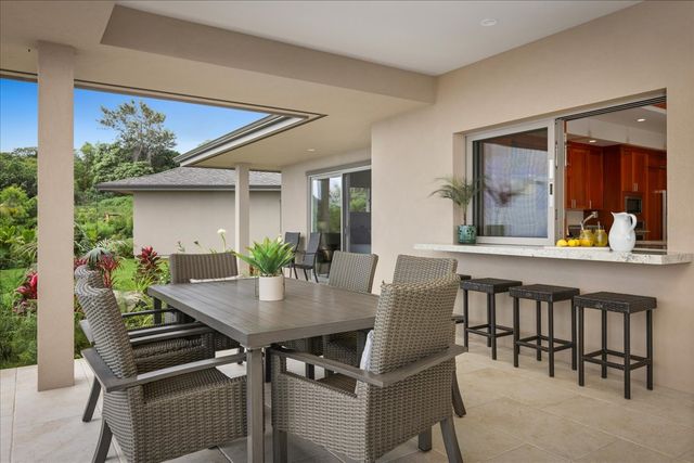 a view of a dining room with furniture and window