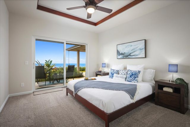 a bedroom with a large bed and a chandelier fan