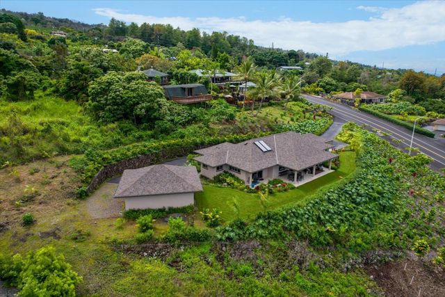 an aerial view of house with yard and outdoor seating