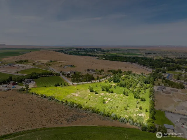 an aerial view of a houses with a yard