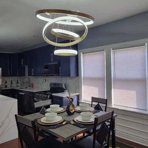 a kitchen with a table chairs stove and cabinets