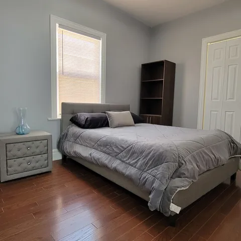 a bedroom with a bed and a window